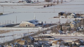 5.5K aerial stock footage orbit a church near homes with winter snow, Heber City, Utah Aerial Stock Footage | AX126_324