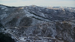 5.5K aerial stock footage fly over Park City mansions at the base of a snowy mountain at sunset, Utah Aerial Stock Footage | AX127_035