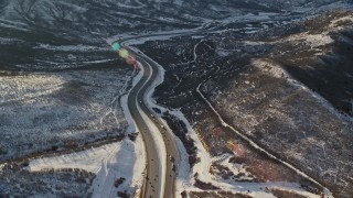 5.5K aerial stock footage of cars and big rigs on I-80 through the Wasatch Range in winter at sunset, Utah Aerial Stock Footage | AX127_047E