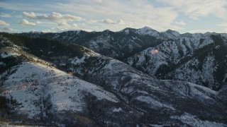 5.5K aerial stock footage of Wasatch Range mountains covered in light winter snow, Utah Aerial Stock Footage | AX127_049E