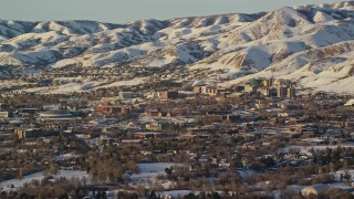 5.5K aerial stock footage of approaching the University of Utah campus at the base of snowy mountains at sunset Aerial Stock Footage | AX127_077