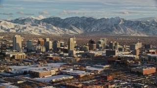 5.5K aerial stock footage orbit west side of Downtown Salt Lake City with winter snow at sunset, Utah Aerial Stock Footage | AX127_094