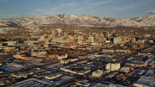 5.5K aerial stock footage orbit of Downtown Salt Lake City with winter snow at sunset, Utah Aerial Stock Footage | AX127_098E