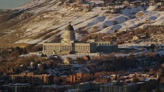 5.5K aerial stock footage orbit Utah State Capitol by snowy hills at sunset in wintertime, Salt Lake City Aerial Stock Footage | AX127_104E