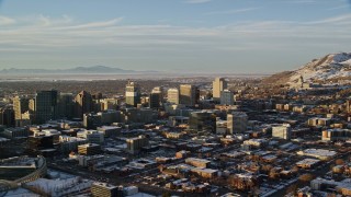 5.5K stock footage video of passing by Downtown Salt Lake City near Utah State Capitol with winter snow at sunset Aerial Stock Footage | AX127_106