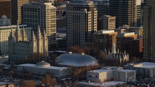 5.5K aerial stock footage orbit Salt Lake Temple and Tabernacle at sunset with winter snow, Salt Lake City, Utah Aerial Stock Footage | AX127_118E