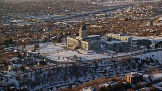 5.5K aerial stock footage reverse view of the Utah State Capitol at sunset with winter snow, Salt Lake City Aerial Stock Footage | AX127_125