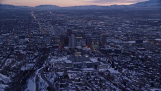 5.5K aerial stock footage fly over north side of the state capitol building to approach Downtown SLC with winter snow at sunset, Utah Aerial Stock Footage | AX128_015E