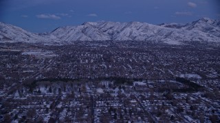 5.5K aerial stock footage of suburban Neighborhoods and Liberty Park with winter snow at twilight, Salt Lake City, Utah Aerial Stock Footage | AX128_029