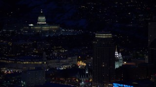 AX128_103 - 5.5K aerial stock footage orbit the Utah State Capitol and Salt Lake Temple at night in winter, Downtown Salt Lake City, Utah