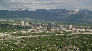 5.5K aerial stock footage of flying by the city, Wasatch Range in the distance, Downtown Salt Lake City, Utah Aerial Stock Footage | AX129_003E