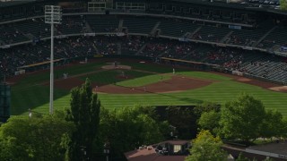 AX129_030E - 5.5K aerial stock footage of circling Spring Mobile Ballpark with players on the field, Salt Lake City, Utah