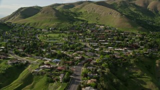 5.5K aerial stock footage of flying by hilltop suburban neighborhood, Wasatch Range, Salt Lake City, Utah Aerial Stock Footage | AX129_059