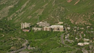 5.5K aerial stock footage video of passing by apartment buildings, Wasatch Range foothills, Salt Lake City, Utah Aerial Stock Footage | AX129_082E