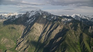 5.5K aerial stock footage approach and pan across the snow-capped peaks, Wasatch Range, Utah Aerial Stock Footage | AX129_100E