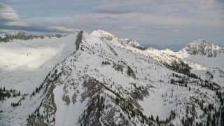 5.5K aerial stock footage pan across and approach snow-covered mountains, Wasatch Range, Utah Aerial Stock Footage | AX129_114E