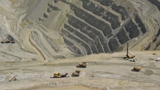 5.5K aerial stock footage of orbiting around gravel haulers, Kennecott Copper Mine, Bingham Canyon Mine, Utah Aerial Stock Footage | AX130_050