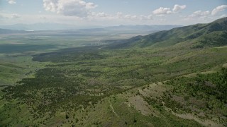 5.5K aerial stock footage of flying over green hills, Oquirrh Mountains, Utah Aerial Stock Footage | AX130_070E