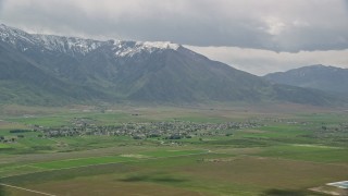 5.5K aerial stock footage of flying by small town near the Wasatch Range, Mona, Utah Aerial Stock Footage | AX130_107E