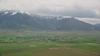 5.5K aerial stock footage of a view of a small rural town by base of Wasatch Range, Mona, Utah Aerial Stock Footage | AX130_109E