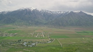 5.5K aerial stock footage of flying by Burraston Ponds, small rural town, Wasatch Range, Mona, Utah Aerial Stock Footage | AX130_113E