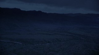 4K day for night color corrected aerial footage of approaching hills with clouds in the sky, Wasatch Range, Utah Aerial Stock Footage | AX130_125_DFN