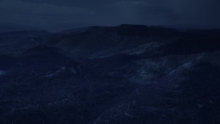 4K day for night color corrected aerial footage of flying by shadowy mountains, trees, Wasatch Range, Utah Aerial Stock Footage | AX130_132_DFN