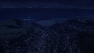 4K day for night color corrected aerial footage of approaching a valley beyond mountain peaks, Wasatch Range, Utah Aerial Stock Footage | AX130_133_DFN