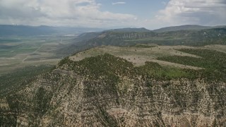 5.5K aerial stock footage of flying by mountain peaks, slopes with trees, Wasatch Range, Utah Aerial Stock Footage | AX130_136E