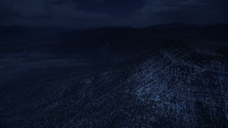 4K day for night color corrected aerial footage of flying by mountain peaks, slopes, trees, Wasatch Range, Utah Aerial Stock Footage | AX130_137_DFN