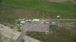 5.5K aerial stock footage of orbiting small planes and hangars, Manti-Ephraim Airport, Ephraim, Utah Aerial Stock Footage | AX130_141