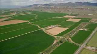 5.5K aerial stock footage of passing by farmland and orbit a barn, Aurora, Utah Aerial Stock Footage | AX130_166E