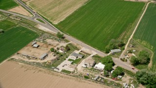 5.5K aerial stock footage of flying by Old Highway 89, farmland, Aurora, Utah Aerial Stock Footage | AX130_172E