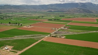 5.5K aerial stock footage of flying by farmland, Route 118, Richfield, Utah Aerial Stock Footage | AX130_189