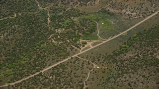 5.5K aerial stock footage of country road, RVs, tree-covered hillsides, Richfield, Utah Aerial Stock Footage | AX130_196E