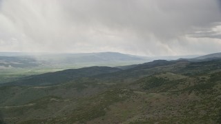 5.5K aerial stock footage of flying by green hills, trees, distant valley, Fishlake National Forest, Utah Aerial Stock Footage | AX130_208