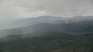 5.5K aerial stock footage of flying by rain falling on mountains, trees, Fishlake National Forest, Utah Aerial Stock Footage | AX130_214