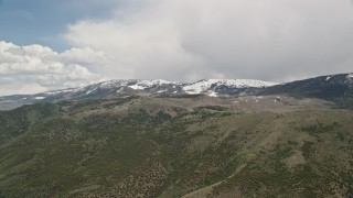 5.5K aerial stock footage of passing by snow-capped and tree-covered green mountains, Fishlake National Forest, Utah Aerial Stock Footage | AX130_216E