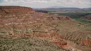 5.5K aerial stock footage of approaching a mesa, surrounded by farmland, Capitol Reef National Park, Utah Aerial Stock Footage | AX130_240E