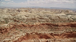 5.5K aerial stock footage of passing by the Waterpocket Fold rock formations, Capitol Reef National Park, Utah Aerial Stock Footage | AX130_264E