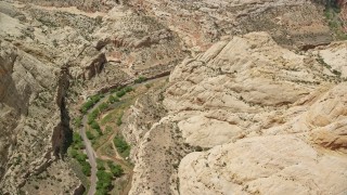 5.5K aerial stock footage of orbiting desert road, Waterpocket Fold rock formations, Capitol Reef National Park, Utah Aerial Stock Footage | AX130_278