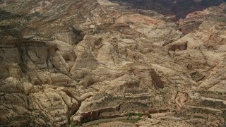 5.5K aerial stock footage of passing part of the Waterpocket Fold rock formations, Capitol Reef National Park, Utah Aerial Stock Footage | AX130_297