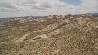 5.5K aerial stock footage approach the Waterpocket Fold rock formations, Capitol Reef National Park, Utah Aerial Stock Footage | AX130_302E