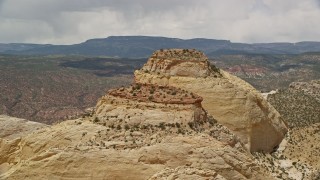 AX130_308 - 5.5K aerial stock footage orbit a pair of Waterpocket Fold rock formations, Capitol Reef National Park, Utah