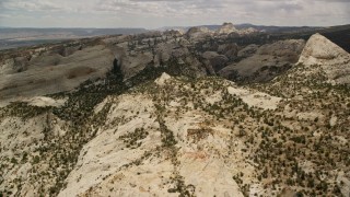 5.5K aerial stock footage approach the Waterpocket Fold rock formations, Capitol Reef National Park, Utah Aerial Stock Footage | AX130_317