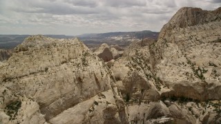 5.5K aerial stock footage of flying over Waterpocket Fold rock formations reveal, Capitol Reef National Park, Utah Aerial Stock Footage | AX130_324E