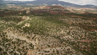 5.5K aerial stock footage of flying over desert hills covered in vegetation, approach a peak, Capitol Reef National Park, Utah Aerial Stock Footage | AX130_337E