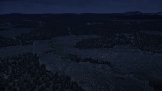 4K day for night color corrected aerial footage of flying over desert valley, green vegetation, Dixie National Forest, Utah Aerial Stock Footage | AX130_346_DFN