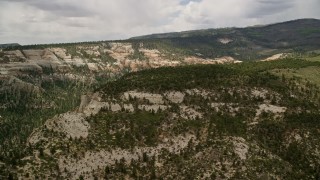 5.5K aerial stock footage of an approach to a wide canyon with desert vegetation, Dixie National Forest, Utah Aerial Stock Footage | AX130_351E