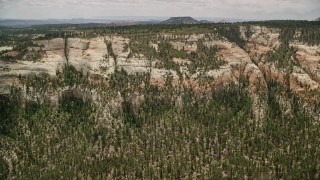 5.5K aerial stock footage of flying by mountain slopes topped with desert vegetation, Dixie National Forest, Utah Aerial Stock Footage | AX130_353